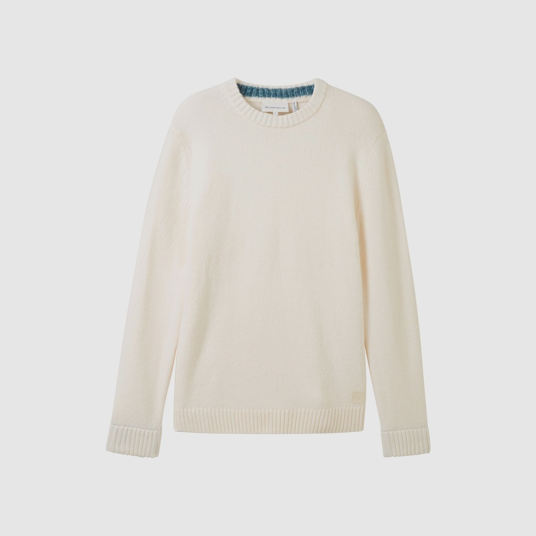 Ein weißer Pullover mit Rundhalsausschnitt und gerippten Ärmelbündchen. Ein weißer Pullover mit Rundhalsausschnitt und gerippten Ärmelbündchen.