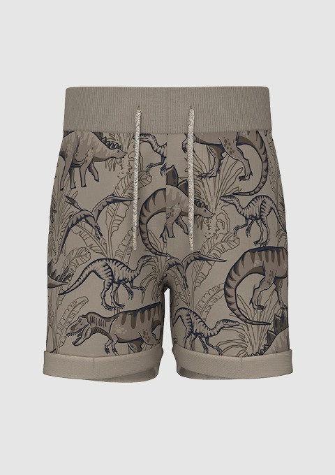 Beige Shorts mit Dinosaurier-Muster. Beige Shorts mit Dinosaurier-Muster.