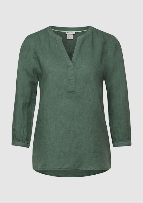 Eine grüne, langärmlige Bluse mit V-Ausschnitt. Eine grüne, langärmlige Bluse mit V-Ausschnitt.